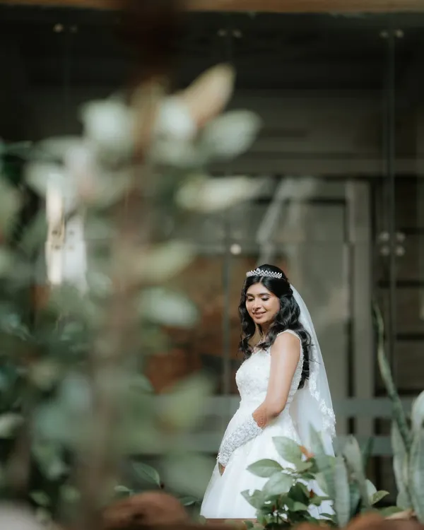 A candid moment of our stunning Catholic bride. We created a soft, dewy look that she had dreamed of, ensuring she glowed with natural radiance.