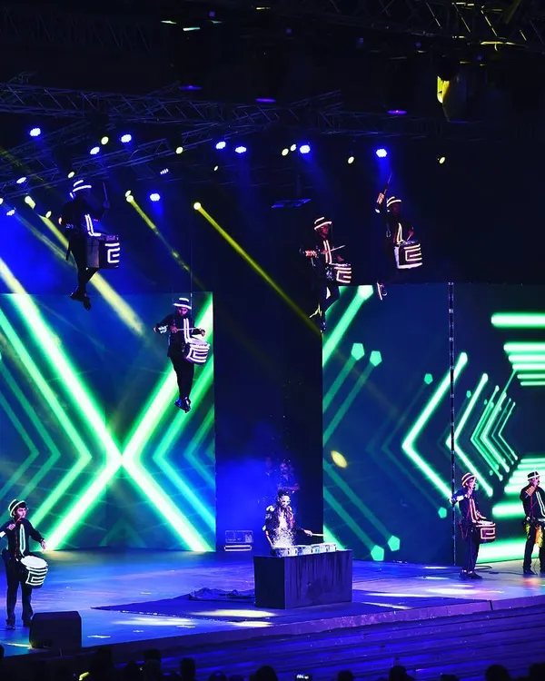 This is my signature Aerial Drumming Troupe in full flight for an Infosys awards ceremony in Bangalore. We rig performers high above the stage, combining synchronized drumming with a massive LED light show for an unforgettable opening act.