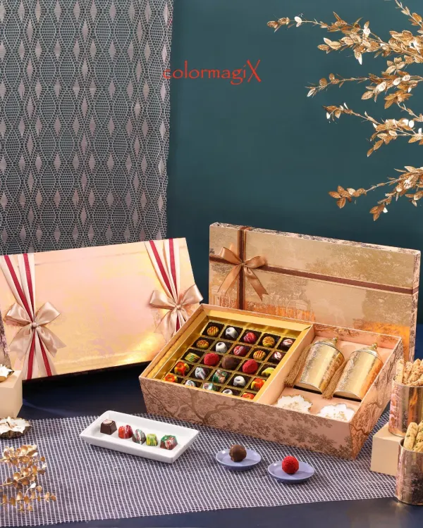 Indulge the senses with our exquisite chocolate and sweets boxes. This opulent gold-foiled hamper contains an assortment of handcrafted chocolates and premium treats, perfect for the discerning connoisseur.