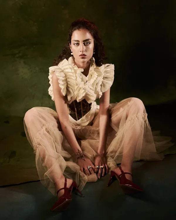 From the 'Velvet Shadows & Tulle Movements' series. This full-length portrait showcases a mix of structured corsetry and ethereal tulle, creating a look that is both historical and rebellious.