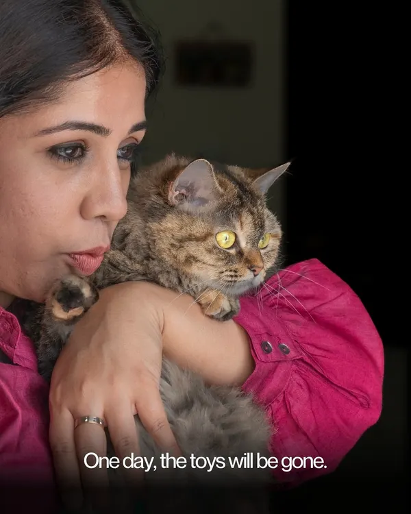 A poignant and intimate portrait of a woman holding her cat close. At-home sessions allow for these deeply personal and emotional moments to unfold naturally.