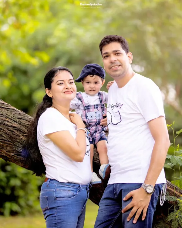 A lovely family of three posing on a tree branch during their outdoor photoshoot. We find unique spots in nature that make for fun and memorable family pictures.