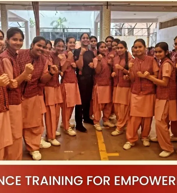 A group of empowered students from Gargi Girls School posing in a fighting stance after their self-defense session.