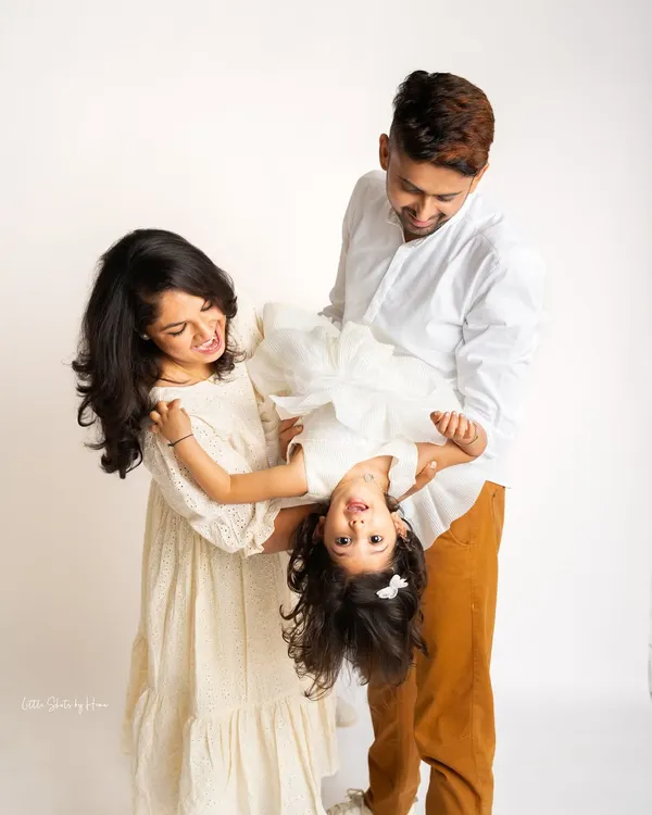 Pure, uninhibited fun during a family photoshoot. This playful moment, with the daughter held upside down, perfectly captures the joyful and candid spirit I love to photograph.
