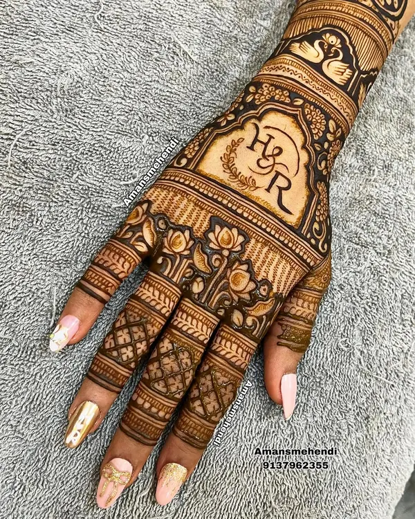 A beautiful back-of-hand design personalized with the couple's initials, "H & R". The monogram is framed by a floral wreath and surrounded by lotus and swan motifs.