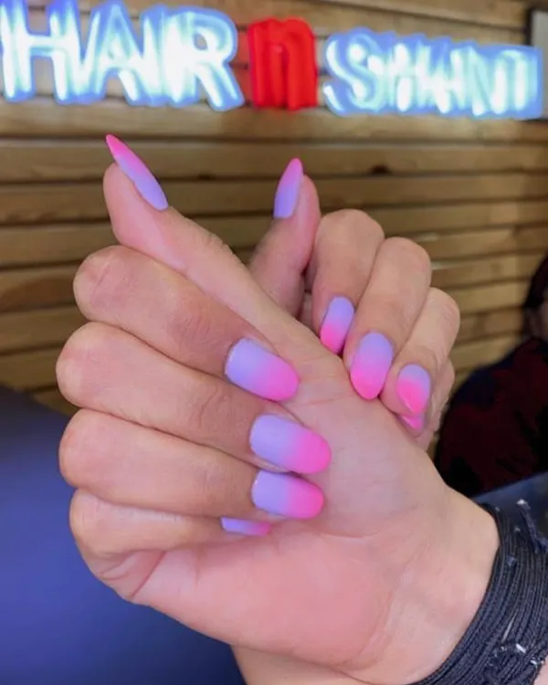 A stunning matte ombre nail extension, blending from a soft purple base to a vibrant pink tip. This popular design showcases our skill in creating smooth color gradients for a modern, eye-catching look.