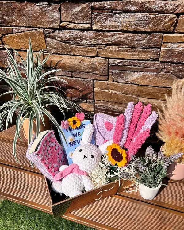 The perfect gift box for your book-loving friend. We curated this special hamper with a book, a handmade crochet bunny plushie, a crochet book sleeve, and flower bookmarks.