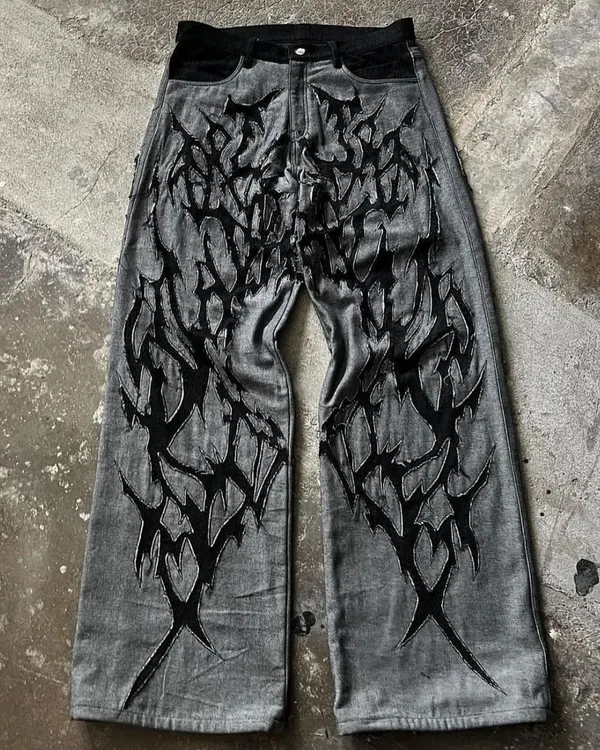 This is what "your style, stitched by me" means. These custom grey jeans feature a bold, hand-cut black appliqué design, creating a one-of-a-kind piece based on a client's vision.