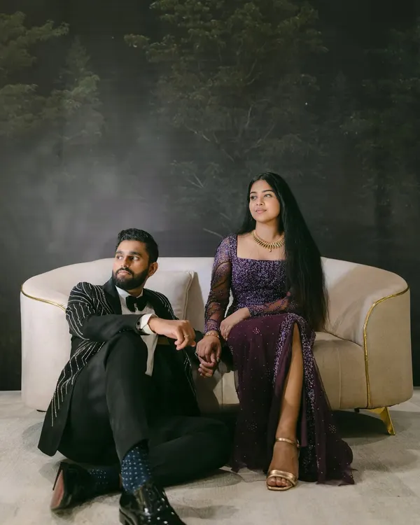 A dramatic and moody portrait of Mariam and Joseph. This styled indoor shoot with a forest backdrop creates a cinematic, fairytale atmosphere, highlighting their elegant attire and unique chemistry.