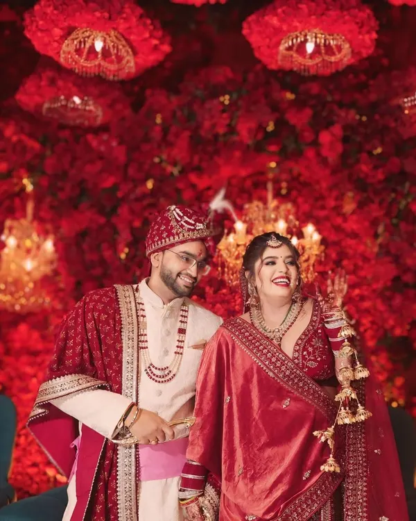 A stunning couple framed by a sea of red florals. I love using decor to create a grand, cinematic backdrop for wedding portraits that feel both epic and intimate.