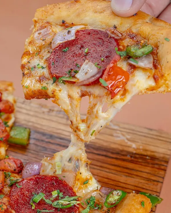 The perfect cheese pull isn't an accident. We shot this pepperoni pizza for Khameera, using specific lighting and angles to capture that irresistible, gooey texture that makes customers crave a slice.