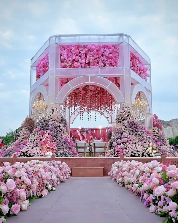 A breathtaking mandap that appears to float on water, enveloped in a sea of pink florals. This is the kind of fairytale setting I love to help create, where every detail feels like it's straight out of a dream.