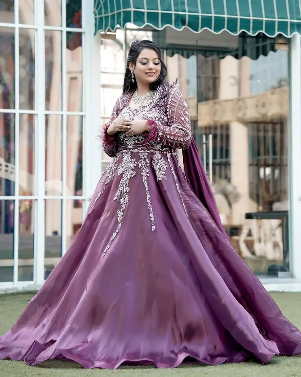 A full-length portrait of the bride in her magnificent purple engagement gown, a picture of pure elegance.