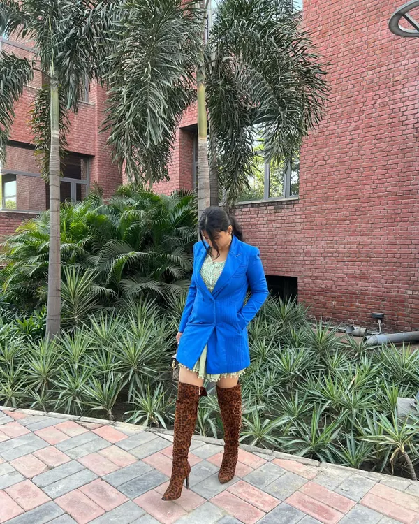 A full view of a chic western look I styled. The combination of a bold blue blazer, a short printed dress, and statement leopard print boots creates a look that is confident and fashion-forward.