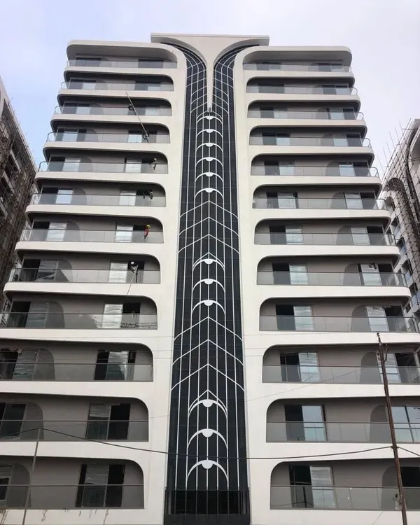 A detailed view of the completed facade at Rajhans Cremona. The central spine features a delicate, string-like pattern, reinforcing the violin-inspired theme and adding a layer of intricate detail to the building's exterior.