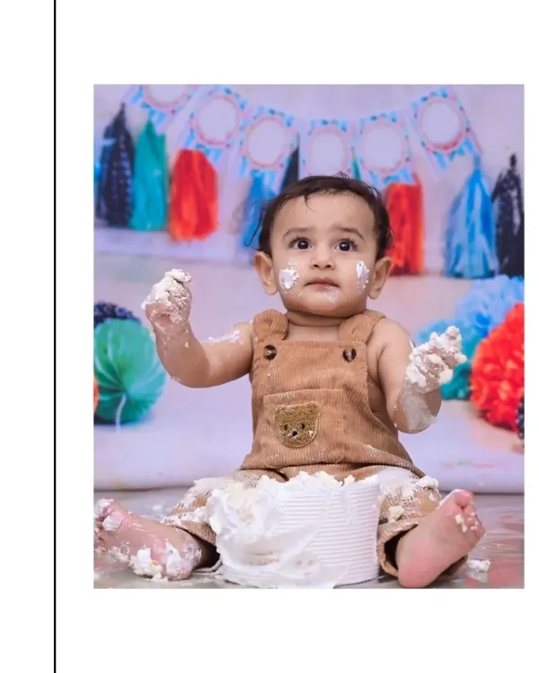 With frosting on his hands and face, this little one is fully embracing his first cake smash. I focus on capturing these authentic, messy moments of discovery and delight.
