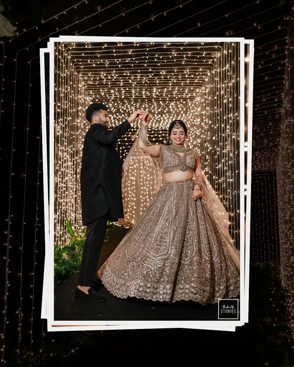 Dancing under a tunnel of fairy lights. This magical shot captures the couple in their own world, twirling during their reception, creating a moment that is both grand and intimate.