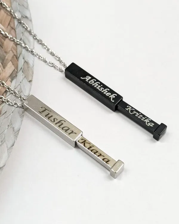 Keep your loved one's name close with this hidden name bar pendant. One name is visible, while the other slides out for a sweet surprise. It’s available in both black and silver stainless steel.