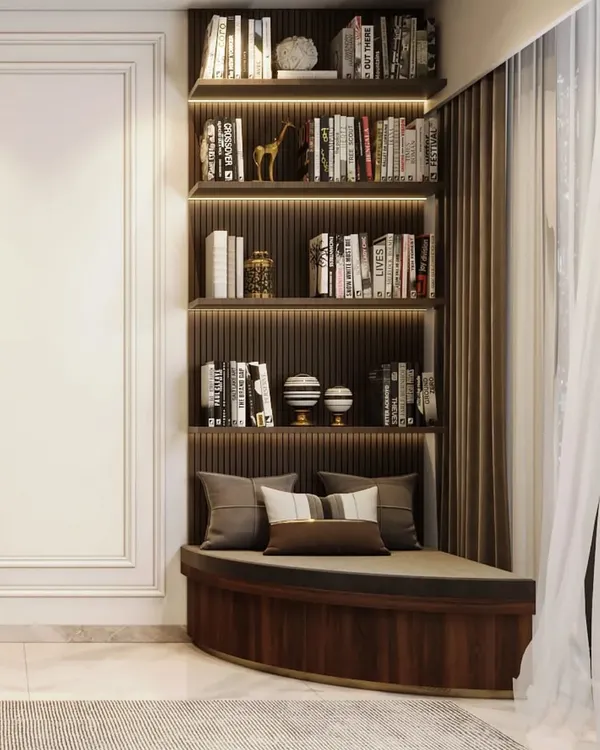 We turned this corner into a reader's paradise with a custom-built curved window seat and an integrated, backlit bookshelf. It's the perfect spot to get lost in a good book.
