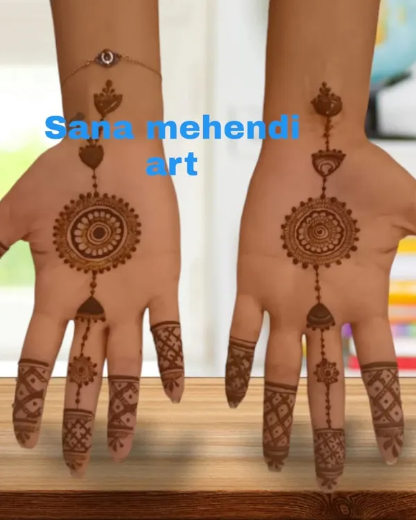 A perfect example of a jewellery-style mehndi design. This pattern mimics a haath phool (hand harness), with a central mandala and chains connecting to the fingers.