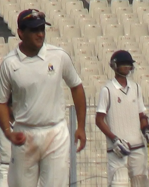 A memory from my professional career during the 2011-12 Ranji Trophy season. Here I am on the field at Eden Gardens during a Delhi vs Bengal match with the legendary Sourav Ganguly. This experience at the highest level of domestic cricket shapes the professional standards I bring to my coaching.