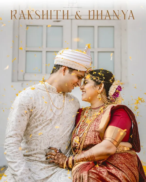 A beautiful, candid moment between Rakshith and Dhanya, showered in golden petals. This fine-art portrait captures their connection, with the bride's traditional red Kanjeevaram saree and temple jewelry shining through.