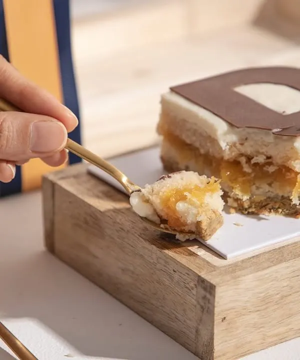 A perfect spoonful of our special Father's Day cake, revealing the light and fruity layers within. A dessert made to celebrate heroes.