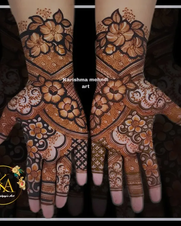 A stunning floral design where large, shaded flowers are the main focus. The symmetrical pattern flows from the forearms to the fingertips, creating a look that is both bold and feminine.