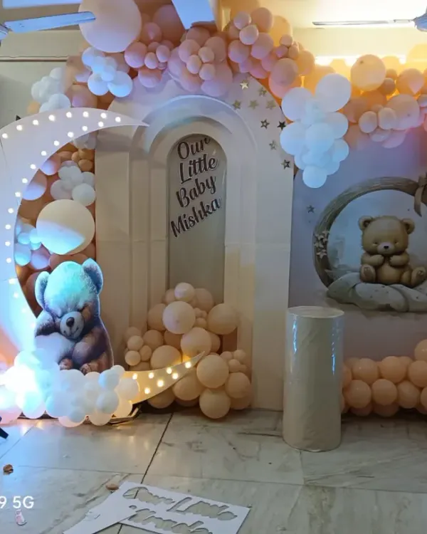 A dreamy moon and teddy bear theme for a baby shower, perfect for creating a magical atmosphere right in your home. The glowing crescent moon, soft clouds, and sleeping teddy cutouts make for a beautiful photo backdrop to celebrate your little one.