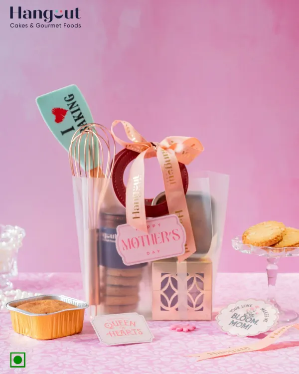 A hamper for the mom who loves to bake. This Mother's Day gift includes fun baking tools, wholesome orange cake, cookies, and calming tea, all wrapped in a chic transparent bag.