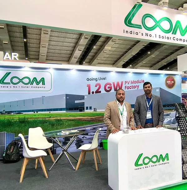 Our team at the Global Solar Expo, standing by our professionally designed booth. The backdrop highlights our upcoming 1.2 GW PV Module Factory, a testament to our commitment to scaling up solar manufacturing in India.