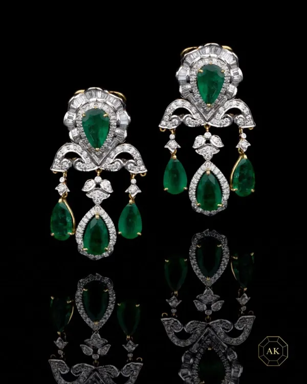 A statement jewel is your voice before you even speak. These emerald and diamond chandelier earrings are crafted for women who command a room. The design features pear-shaped Zambian emeralds surrounded by a halo of brilliant diamonds, creating an aura of undeniable elegance.