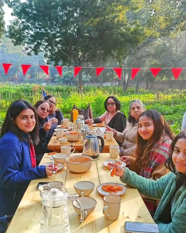 Welcome to our table. Here, surrounded by nature, we share meals made from the freshest ingredients, grown just steps away. This is more than just eating; it's about connecting with food, the earth, and each other.