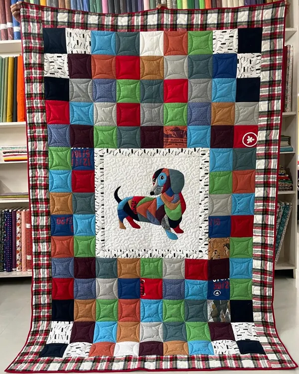 We specialize in creating one-of-a-kind memory quilts that tell a personal story. This piece, made for a client's son, transforms cherished t-shirts into a beautiful keepsake, featuring a custom appliqué dachshund and detailed longarm quilting.