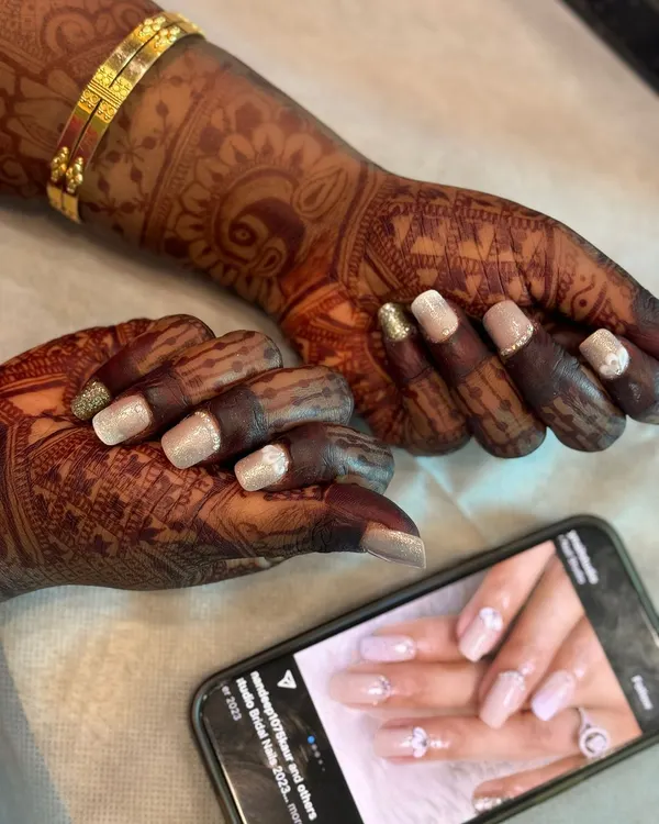 Beautiful custom nail art for my bride Poornima. She chose a delicate design with glitter and embellishments that perfectly matched her wedding attire. We offer this service through Narumugai Nail Art Studio.