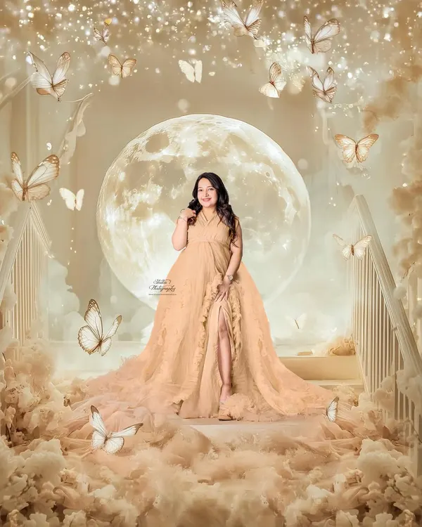 A true fairytale moment. This fantasy composite, created in my studio, features a glowing moon, soft clouds, and butterflies to capture the magical feeling of expecting.