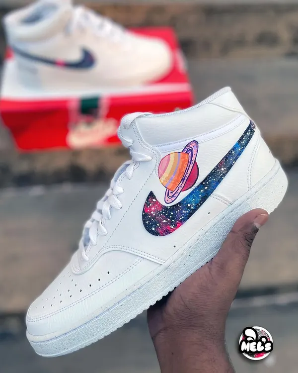 Take your love to the cosmos with these matching galaxy-themed Nike high-tops. One shoe features a vibrant, hand-painted galaxy swoosh with the planet Saturn, perfect for a couple's set.