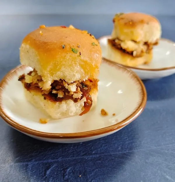 A gourmet twist on the beloved street-side classic. These mini fusion sliders are packed with a spicy, tangy masala, topped with crumbled paneer, and nestled in soft, butter-toasted buns.