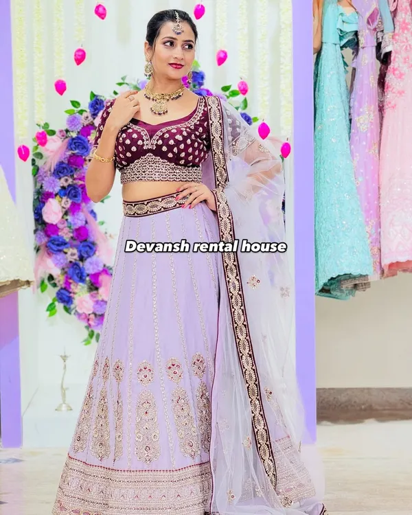 A stunning lavender lehenga with intricate embroidery, paired with a rich velvet blouse. This piece is available for rent and is perfect for a sangeet or reception, giving you a royal look.