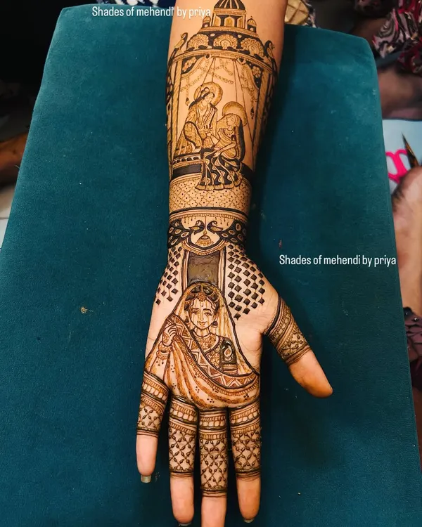 A full bridal arm telling a story. This design includes a bride portrait on the hand and a detailed doli scene on the forearm, capturing the emotion of the wedding day.