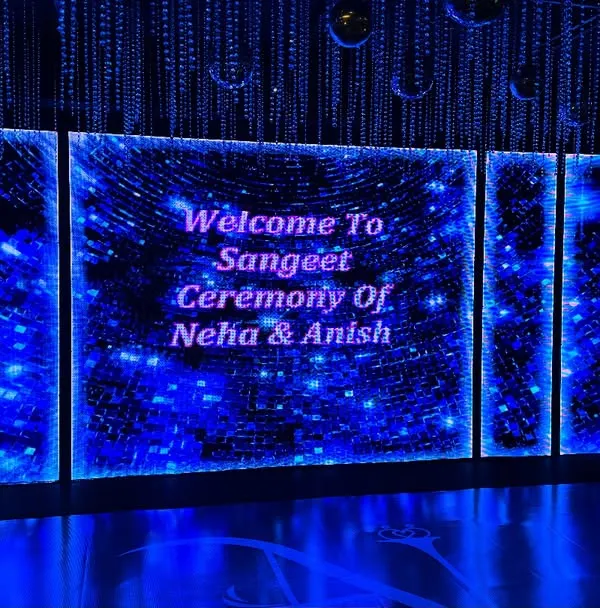 A futuristic and dazzling welcome screen for Neha and Anish's Sangeet ceremony. We used a large LED wall with cosmic-themed graphics to build excitement for a night of music and dance.