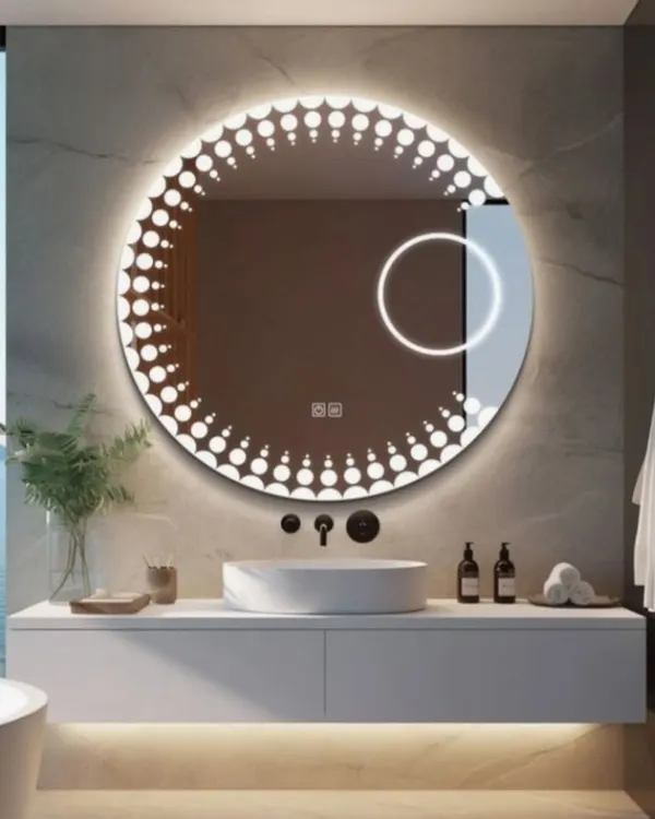 **(Hero Item)** A look at our custom circular LED mirror, designed for a modern bathroom. This piece features a stylish dotted backlight pattern for even illumination and an integrated magnifying circle for detailed grooming. We can customize the size, light temperature, and add smart features like defoggers.