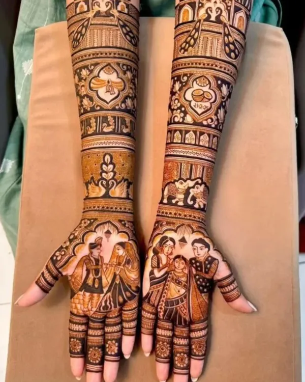 This full bridal mehandi tells a complete family story, with portraits of the couple and their loved ones on the palms. The arms are adorned with traditional motifs, including wedding rituals and auspicious symbols, creating a rich and personal design.