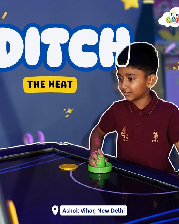 Ditch the heat and dive into our cool arcade! This young gamer is focused on his air hockey match, enjoying a fun-filled day away from the summer sun.