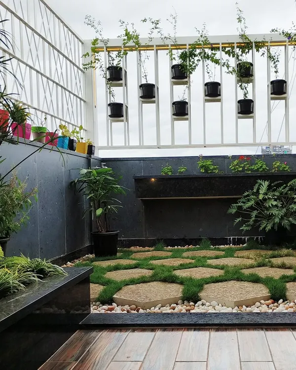 This terrace garden for the 'Opulent Abode' penthouse is a perfect urban sanctuary. I used hexagonal stone pavers with grass joints, a small water feature, and a calming Buddha statue to create a space for peace and meditation.