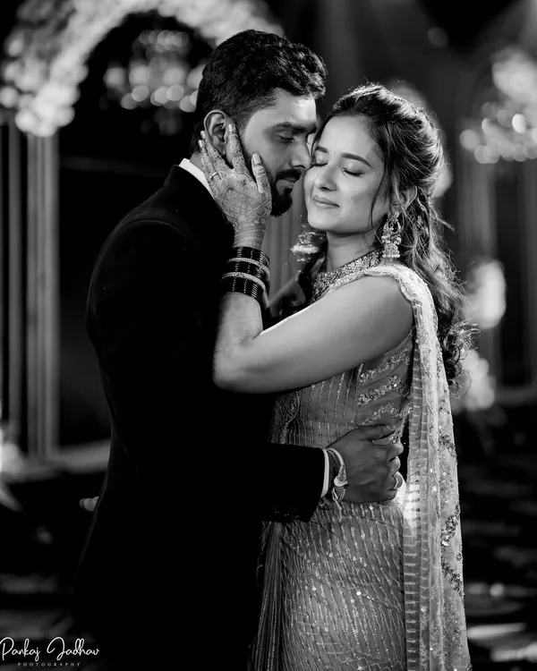 In this black and white portrait from their sangeet, all the focus is on the tender emotion between Sanket and Ruchi. The soft lighting and close embrace create a timeless, romantic feel.