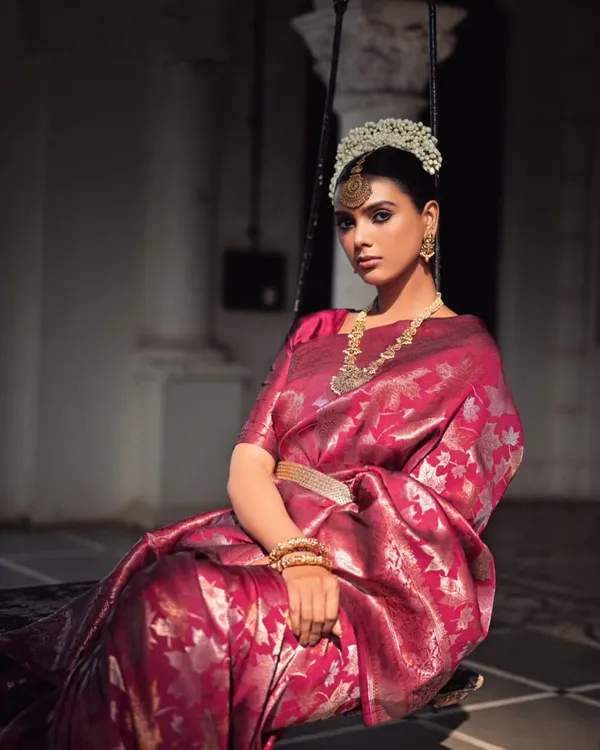 For this saree campaign, I created a look of royal elegance. The model is styled in a rich magenta Banarasi silk saree, complemented by a traditional 'gajra' headpiece and temple jewelry, seated on a swing to evoke a sense of timeless grace.