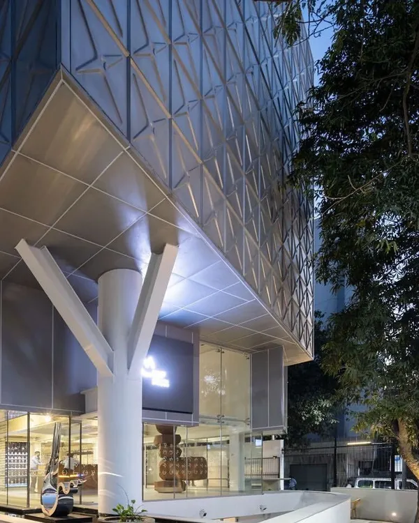 The entrance to MAP is marked by a symbolic tree-like column, grounding the modern structure and creating a welcoming transition from the street into the world of art.