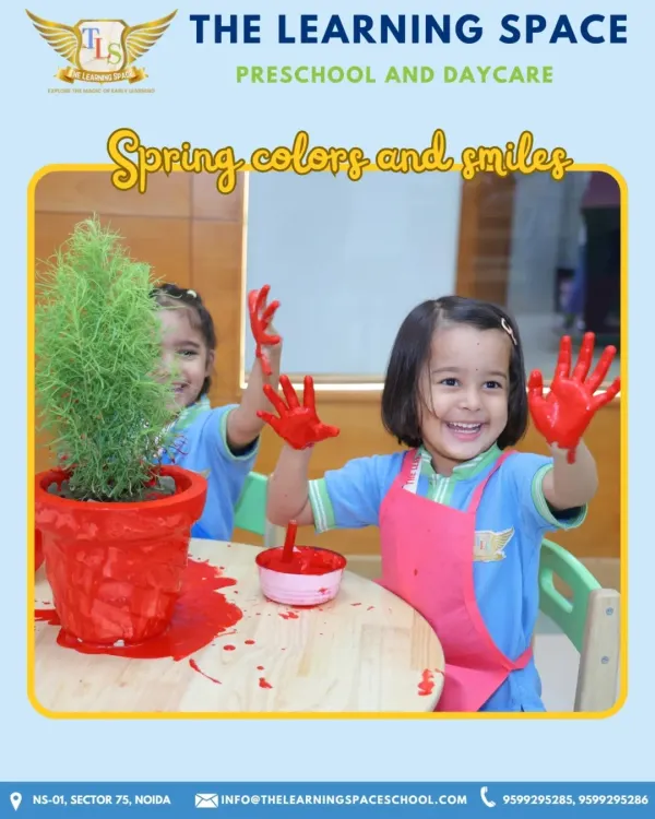 Spring colors and smiles. This joyful photo of a child with paint on her hands perfectly captures the messy, happy, and creative spirit of our art activities.