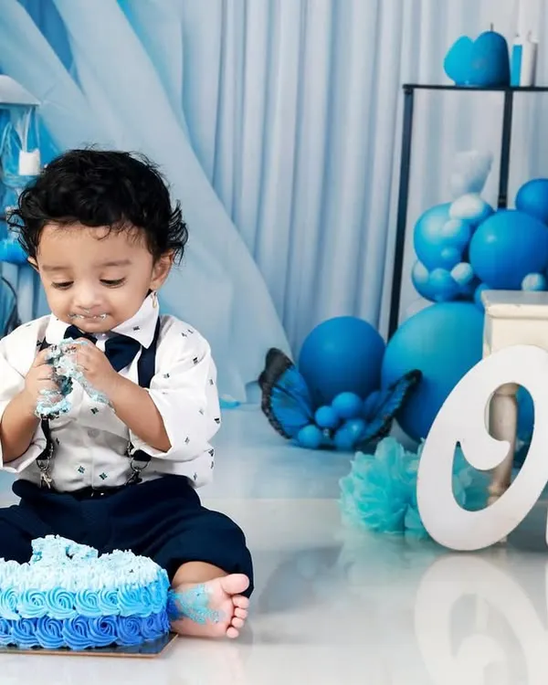 Nothing says "Happy First Birthday" like a cake smash! This little one is having the time of his life with his own cake against our custom blue balloon backdrop. I focus on capturing the messy, candid, and joyful moments of this big milestone.